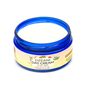 Dzeani Day Cream combines Vitamins C, B3, and E with botanical butters and oils to nourish and soften the skin.